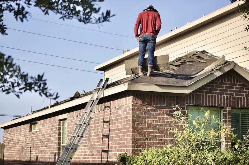 Professional roofer working on a residential roof in Leslie Estates